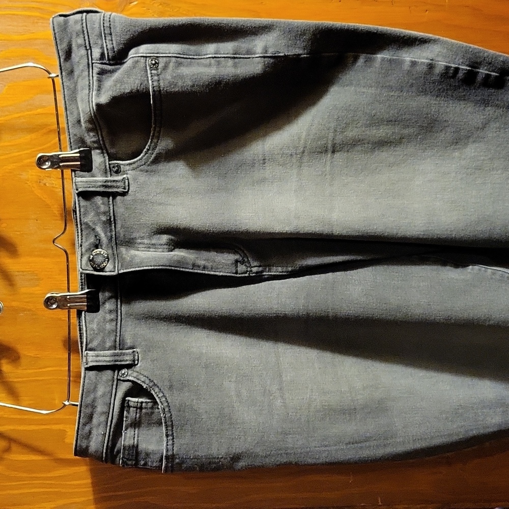 Faded denim jeans with distressed hem